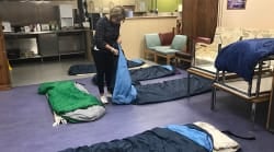 Image of Cork Simon staff laying mattressess on the florr of our Day Centre in preparation for our Night Light emergency accommodation service.