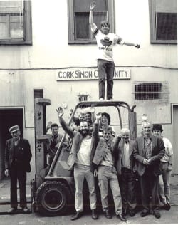 Old black and white image of service users outside Cork Simons first emergency shelter in the early seventies